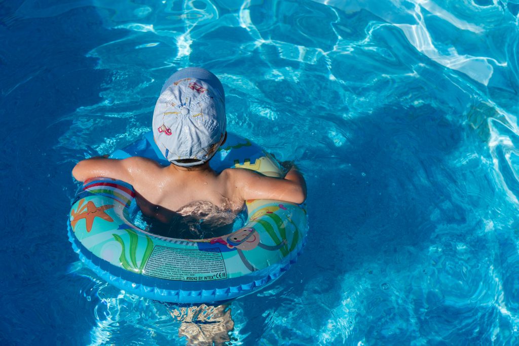 Kid swimming in a pool.