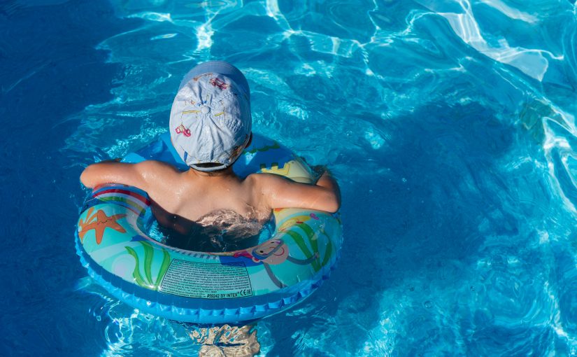 Kid swimming in a pool.